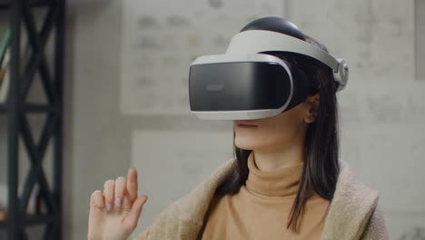 Portrait-Woman-architect-designer-in-virtual-reality-helmet-with-hands-imitates-work-of-interface.-Designing-the-future-the-concept-of-virtual-architecture-and-design-interface-graphic-applications.